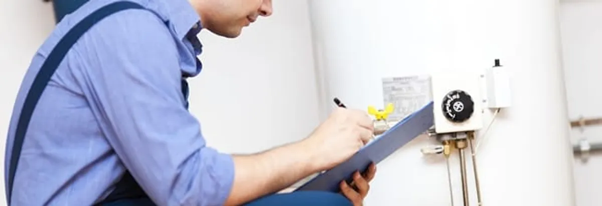 Water heater repair technician inspecting the unit and recording service notes in Chicago, IL